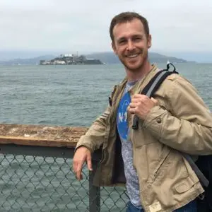 Person posing near ocean, island background