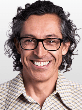 Man with curly hair and big smile