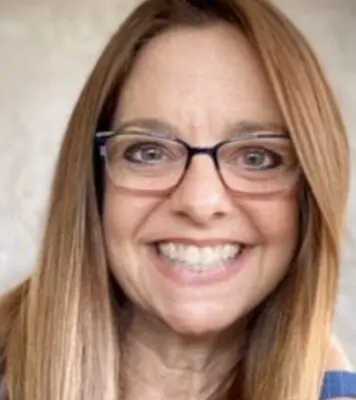 Smiling woman with glasses and long hair