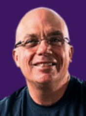 Smiling man with glasses on purple background