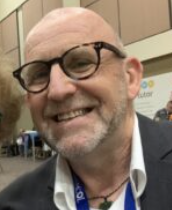 Person wearing glasses and smiling indoors