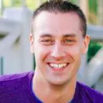 Smiling person in a purple shirt