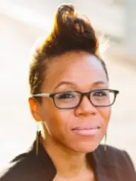 Professional in glasses and earrings outdoors