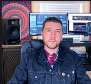 Person in denim jacket at recording studio