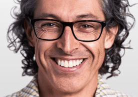 Man with curly hair and big smile