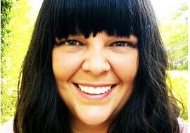 Cheerful person with bangs and dark hair