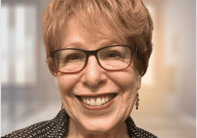 Happy woman in glasses, blurred background