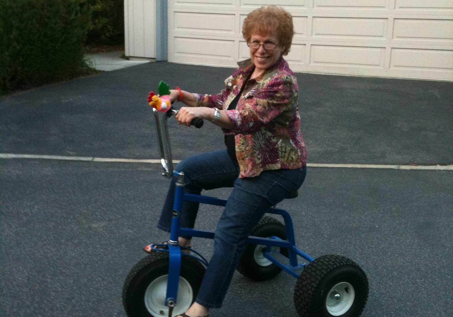 Happy woman on a blue tricycle