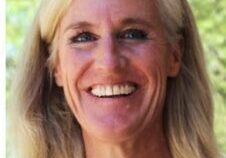 Blonde woman smiling in nature setting