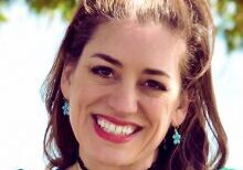Smiling woman outdoors with earrings