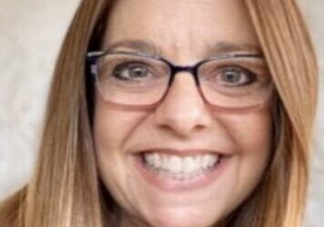 Smiling woman with glasses and long hair