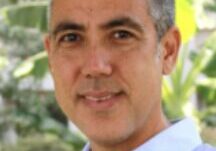 Person in blue shirt, outdoor setting