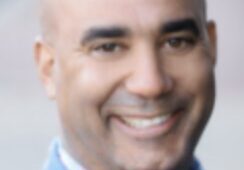 Smiling man in blue shirt