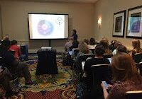 Attendees watching a projected presentation
