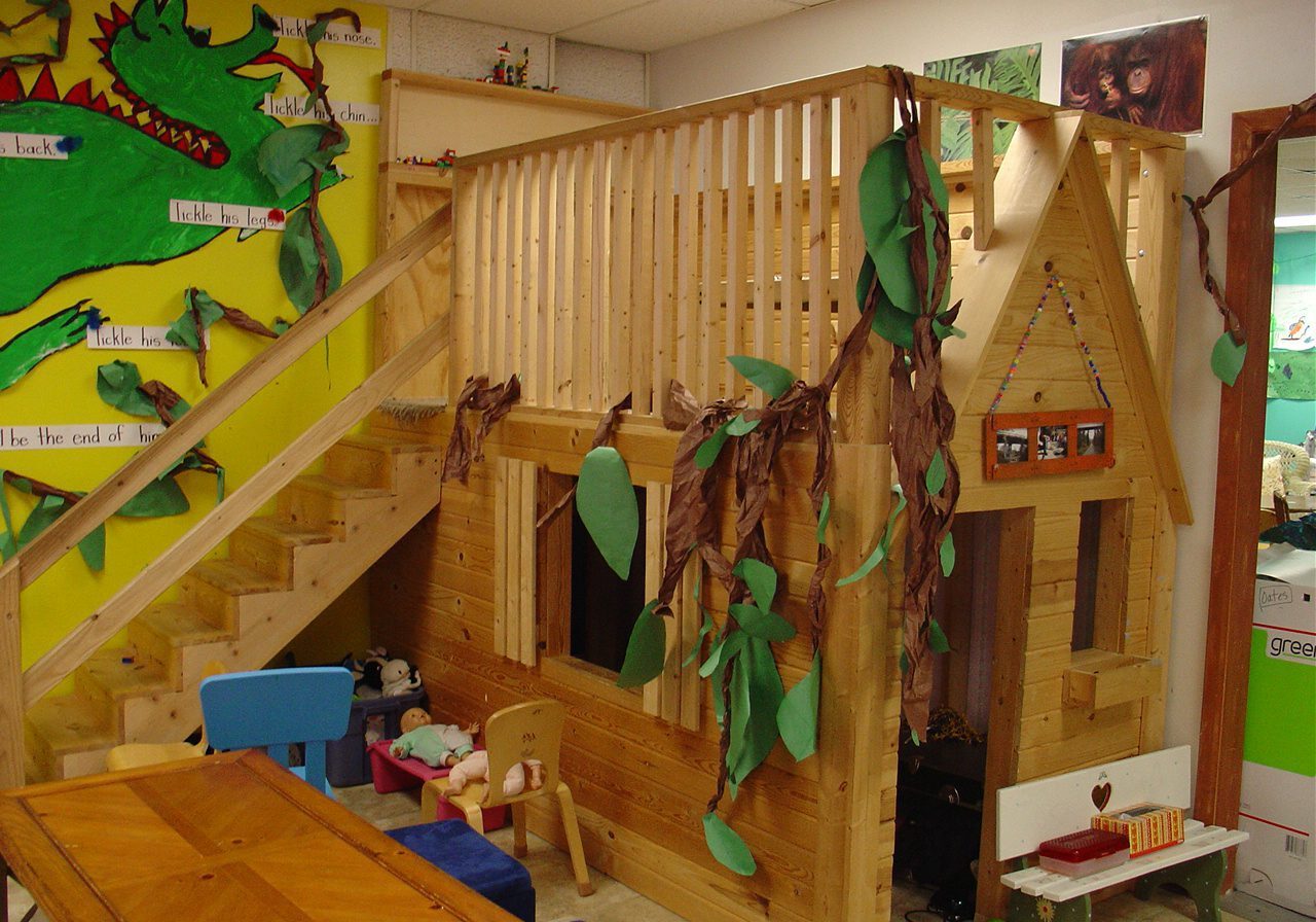 Wooden playhouse with leafy decorations