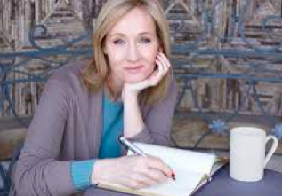 Woman writing in notebook at café table