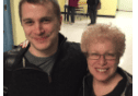 Two smiling people posing indoors