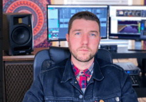 Person in denim jacket at recording studio