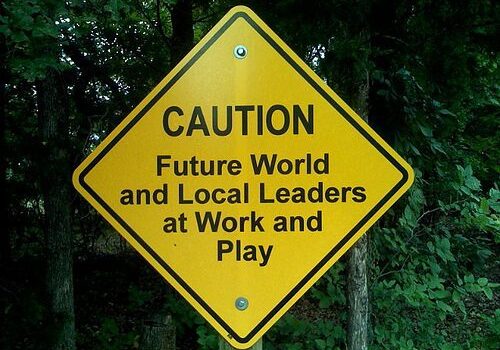 Yellow warning sign near trees