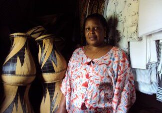 Woman in patterned shirt near crafts