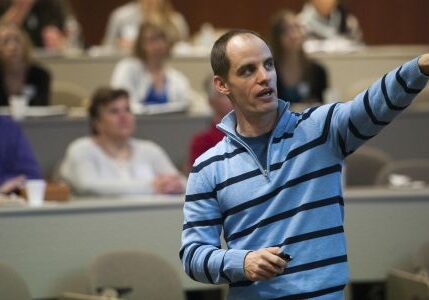 Man giving a presentation in lecture hall